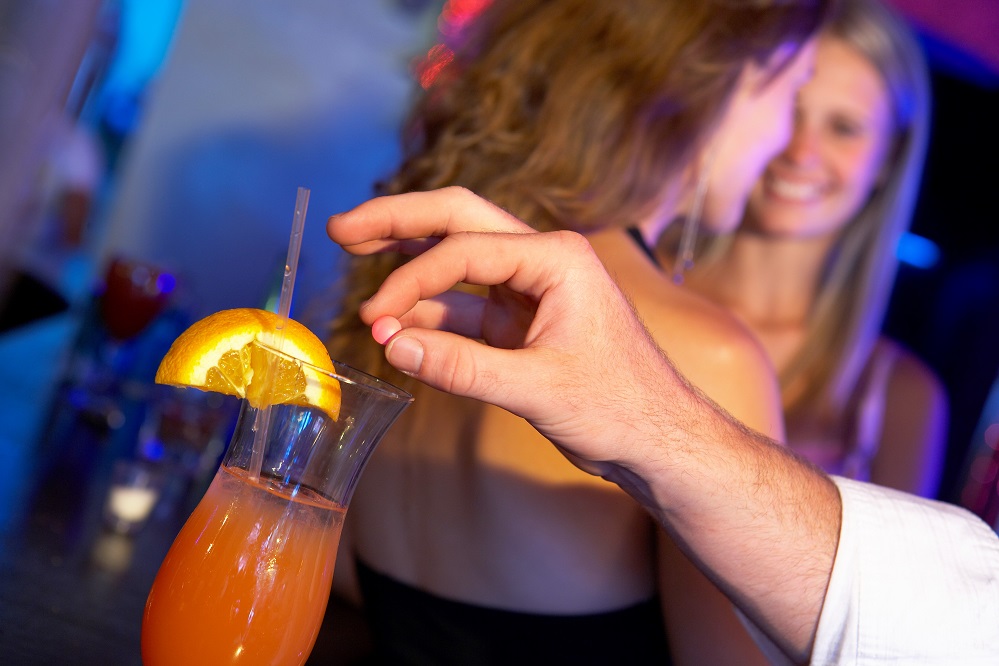 Man Drugging Woman’s Drink In Bar