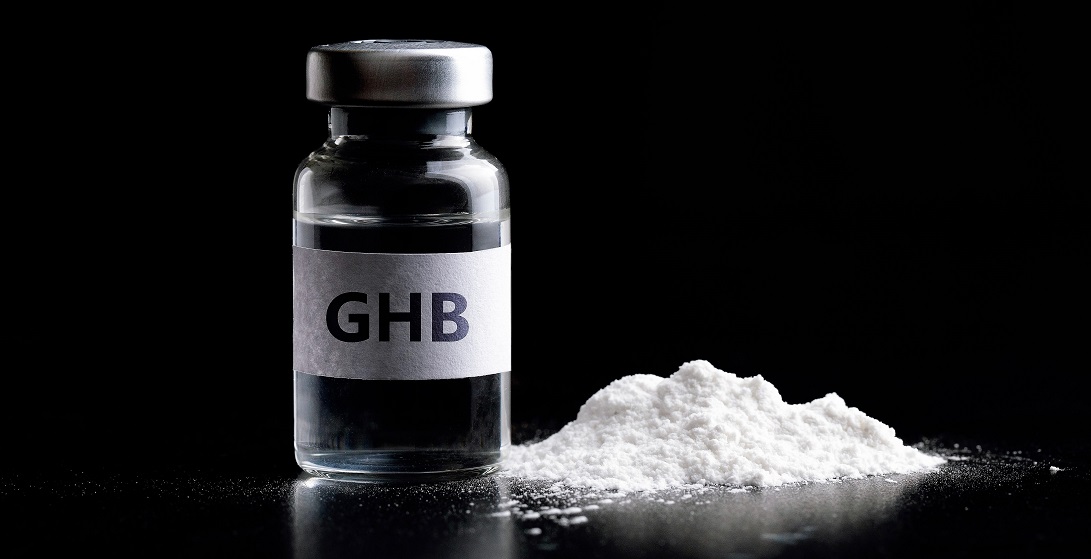 Bottle of GHB in black background.GHB